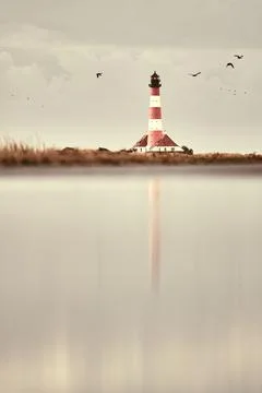 Lighthouse Westerheversand reflection in water Stock Photos