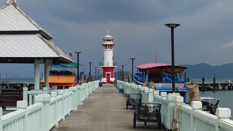 Lighthouse white and red colors with some boats Stock Footage 246798273