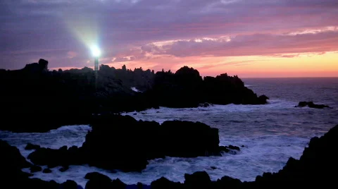 Lighthouse on wild coastline at dusk Stock Footage 538539