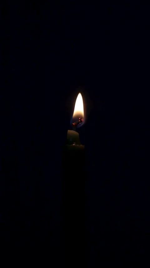 Lighting and  blowing candle in complete darkness.closeup focus on flame Stock Footage 329930464