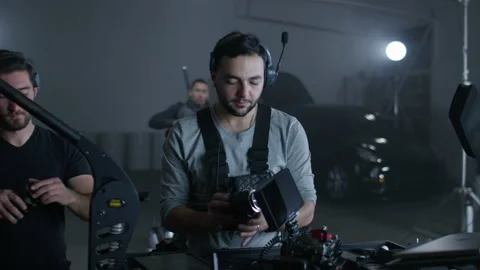 Lighting and camera crews collaborating on a movie set Stock Footage 198274062