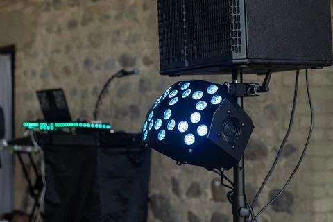 Lighting and sound equipment set up for an evening event in a rustic venue with Stock Photos