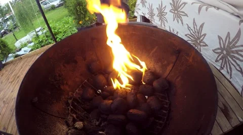 Lighting up black briquettes, in a barbeque Stock Footage 53199857