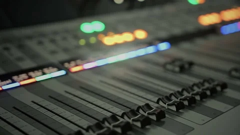 Lighting buttons, adjusting knobs and faders on expensive audio mixing console 動画素材 79122007