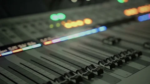 Lighting buttons, adjusting knobs and faders on expensive audio mixing console 動画素材 79123761