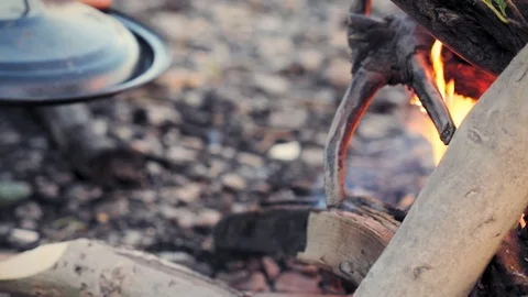 Lighting up a camp fire with a pot lid. 스톡 동영상 116915489
