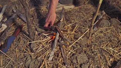 Lighting Campfire with Lighter on Straw Ground Outdoors Stock Footage 346713407