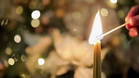 Lighting the candle and Christmas tree branches against background. Stock Footage 251529517