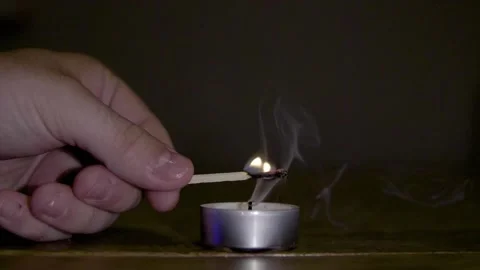 Lighting a candle and letting the flame jump Stock Footage 137459631