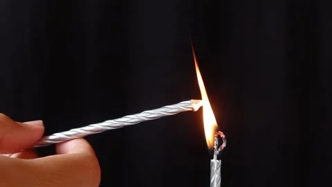 Lighting a candle with another candle Stock Footage 149958278
