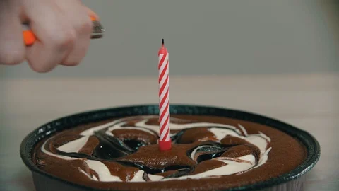 Lighting a candle on a cake with a lighter Stock Footage 118471030