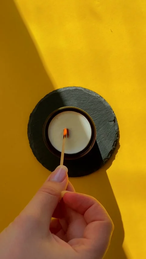 Lighting a candle with a flame, close-up view of wick igniting, concept of Stock Footage 304323180