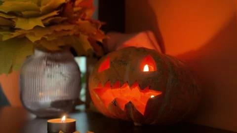 Lighting candle inside Halloween pumpkin with festive autumn decor Stock-Footage 319428899