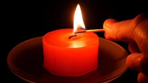 Lighting a candle with a kitchen match Vídeos de archivo 113742690