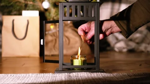 Lighting Candle in lantern with Christmas background Stock Footage 296250019