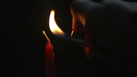 Lighting up a candle with a lighter Stock Footage 95721468