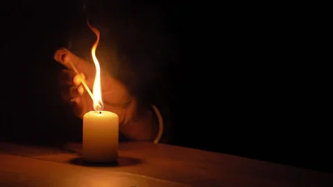 Lighting a candle with a long match Stock Footage 137321375