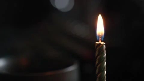 Lighting a candle with match in darkness Stock Footage 218309103