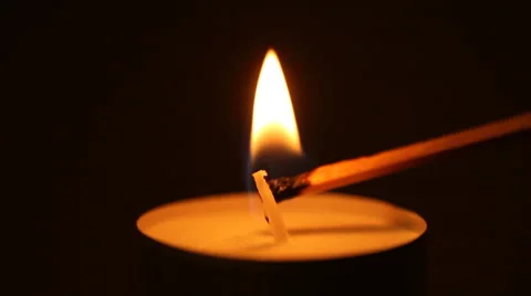 Lighting a candle with a match to get a romantic candlelight Stock Footage 41892313