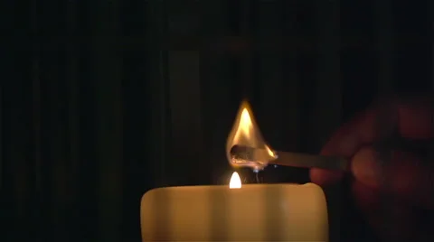 Lighting a candle with match in slow motion. Close Up Stock Footage 48950232