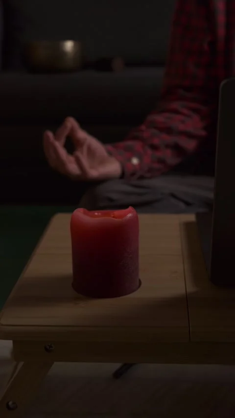 Lighting candle for mindfulness meditation, cozy evening home ritual with laptop Stock Footage 316951853