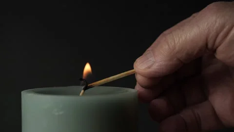 Lighting a candle in slow motion Stock Footage 232247941