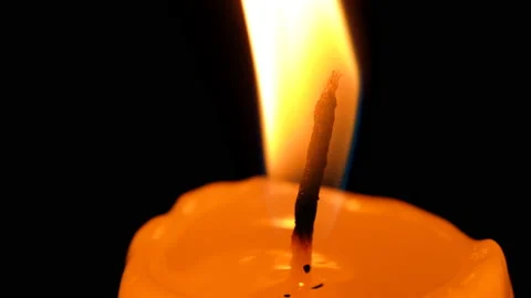 Lighting a candle wick with a match close-up on a black background Stock Footage 164620928
