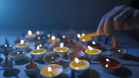 Lighting candle on wood table, woman's hand is lighting a candle Stock Footage 119070752