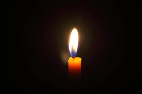 Lighting candles on a black background. Stock Photos