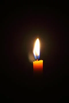 Lighting candles on a black background. Stock-Fotos