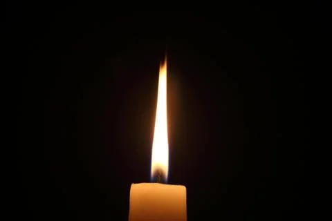 Lighting candles on a black background. Stock-Fotos