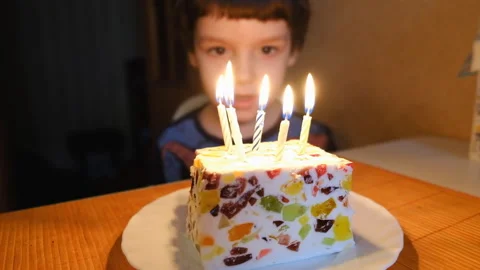 Lighting candles on the cake. Boy blowing candles on a birthday cake. Stock Footage 104272165