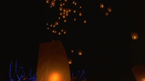 Lighting candles, lanterns in the sky at night in the Lantern Festival Stock Footage 119997090