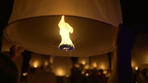 Lighting candles, lanterns in the sky at night in the Lantern Festival Stock Footage 119997546