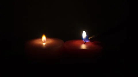 Lighting candles with a lighter Stock Footage 257499387
