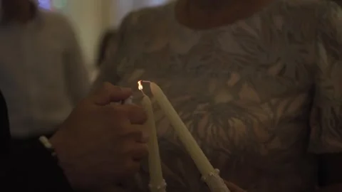 Lighting candles in people's hands 库存影片 306147910