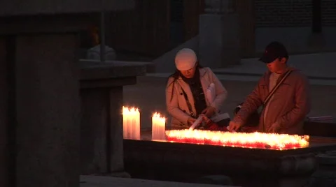 Lighting candles in temple Stock Footage 291308
