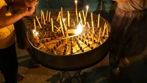 Lighting candles in temple Stock Footage 102598830
