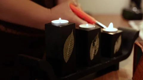 Lighting Candles with a Woman’s Hand Stock Footage 297370837