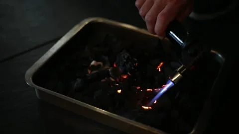 Lighting charcoal with a blowtorch Stock Footage 137945709