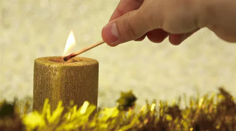 Lighting a christmas candle with match Video stock 30581192