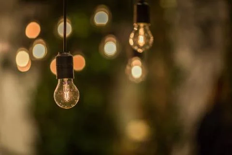 Lighting decor. Retro light bulb filament close up.Illuminated. Фото
