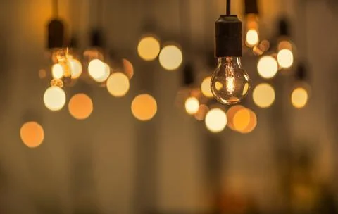 Lighting decor. Retro light bulb filament close up.Illuminated. Фото
