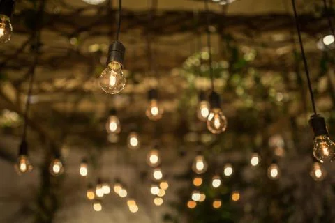 Lighting decor. Retro light bulb filament close up.Illuminated. Фото