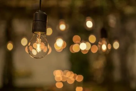 Lighting decor. Retro light bulb filament close up.Illuminated. Фото