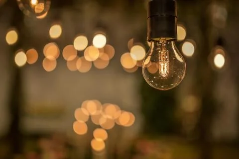 Lighting decor. Retro light bulb filament close up.Illuminated. Фото