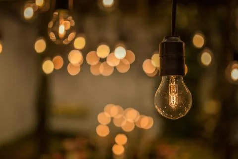 Lighting decor. Retro light bulb filament close up.Illuminated. Фото