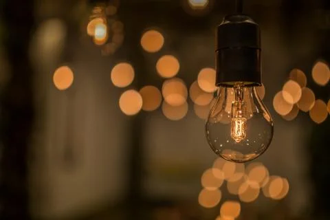 Lighting decor. Retro light bulb filament close up.Illuminated. Фото