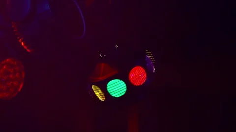 A lighting device with multicolored rays on a theatrical stage in motion Stock Footage 285398677