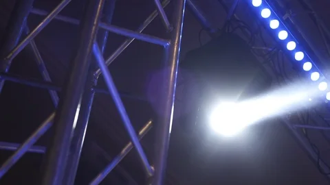 Lighting device with  white beam moves over the stage Stock Footage 124402441